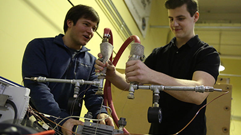Two male students conduct research