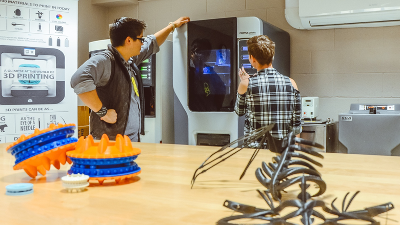 Students wait for 3D printed models to finish in lab space