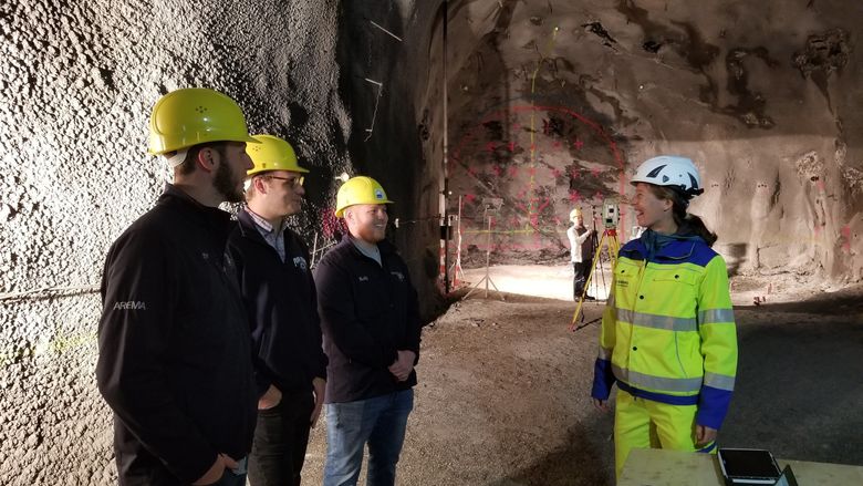 Students and Joe Scott speak with engineer before working on 360-degree video in Europe