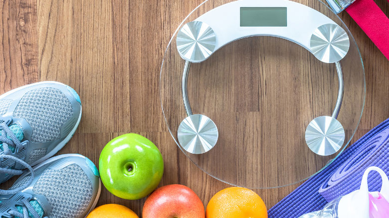 A photo promoting healthy living, including running shoes, pieces of fruit, a water bottle, and a food scale