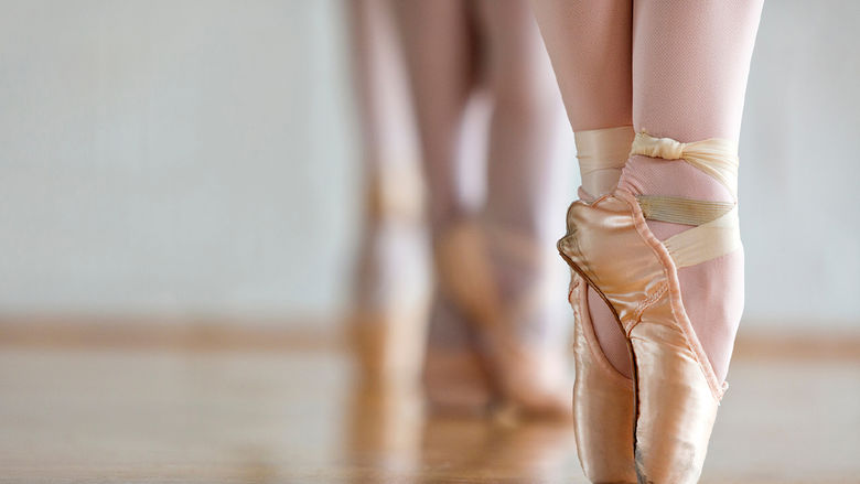 A close-up of a ballet dancer's feet on point