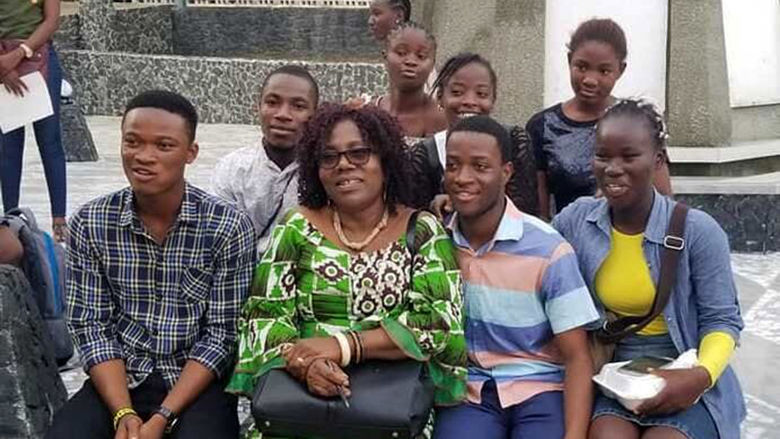 A group of students poses with two of the Mentee-Mentors and Patricia Jabbeh Wesley after the closing program on July 23 in Monrovia, Liberia.