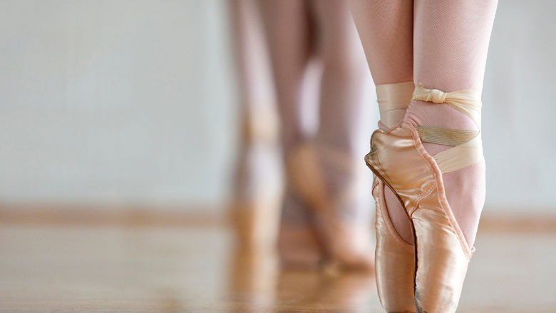 A ballet dancer on pointe in ballet shoes