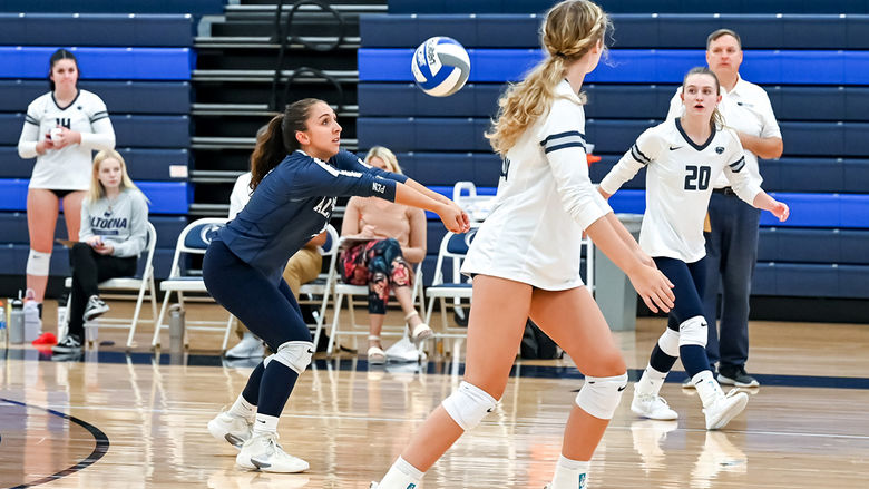 Penn State Altoona volleyball player hits a volleyball during a match