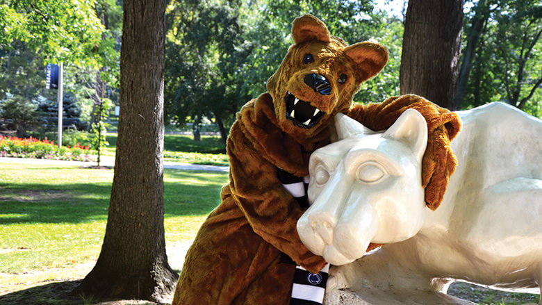 Nittany Lion hugging the Lion Shrine statue