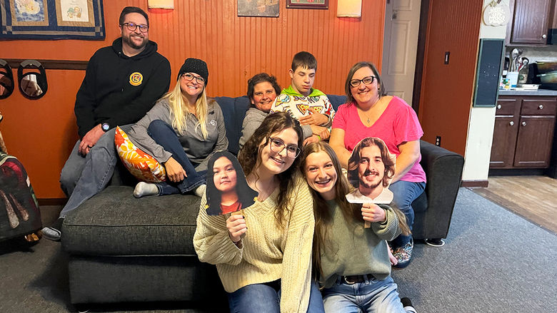 The Lill family poses for a photo with Dr. Laura Palmer and the students in her biology class