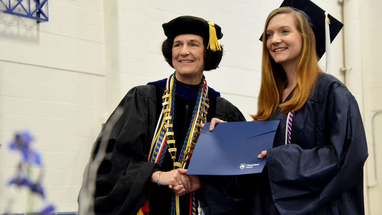 Lori Bechtel-Wherry posing with graduate