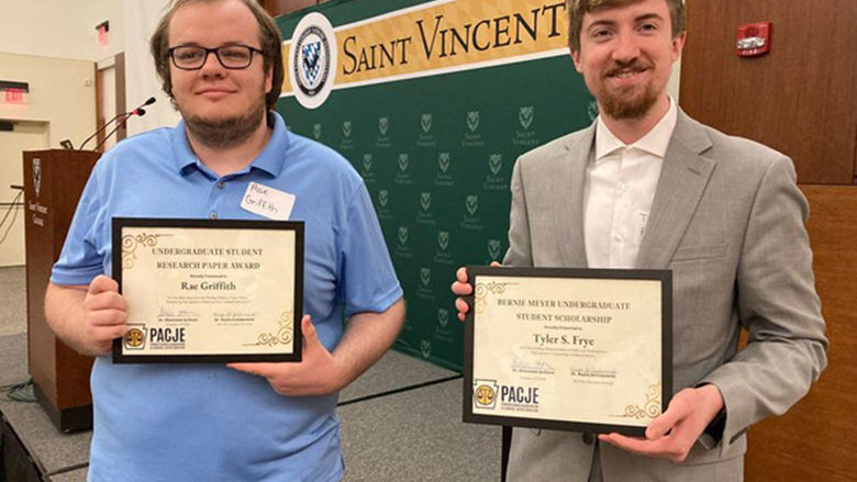 Rae Griffith (left) and Tyler Frye show off their awards from the PACJE conference.
