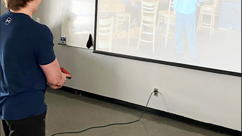 First-year criminal justice student Cole Remsnyder participates in PSP use of force simulator training.