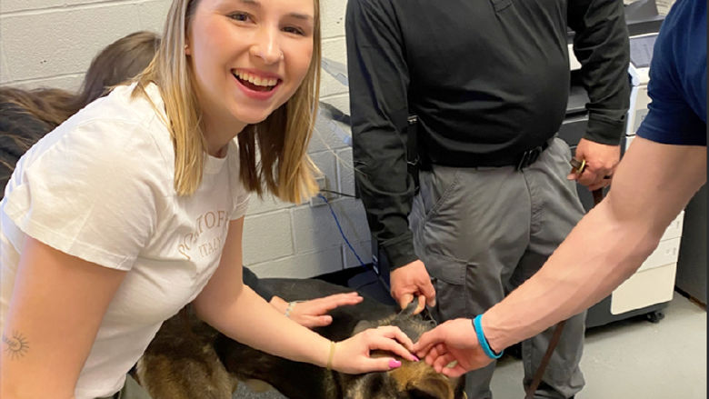 Third-year criminal justice student Lacee Barnhart learns about the PSP K9 unit