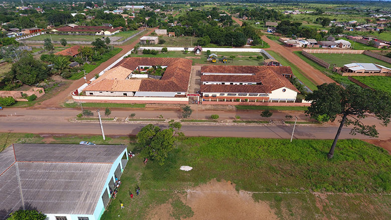 A drone picture of Andrea’s Home shows the four residences, the school, chapel, activity/dining hall, and playground with ballfields.