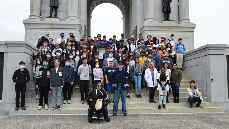 A large group of students standing on steps in front of the Pennsylvania Memorial