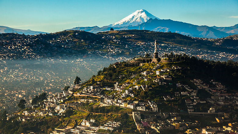 A photo showing the landscape of Ecuador with a snow-capped mountain in the background