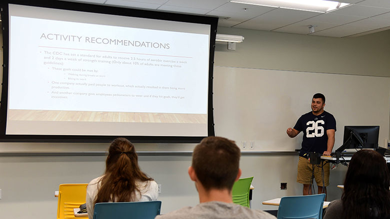A Kinesiology student presenting research
