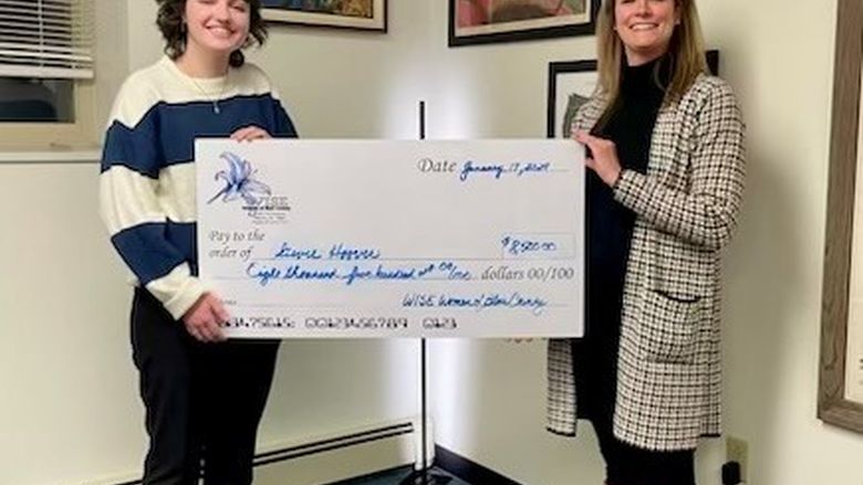 Penn State Altoona student Stevie Hoover receives a scholarship from the WISE Women of Blair County, presented by WISE Women Board President and Scholarship Chair Mandy Michelone.