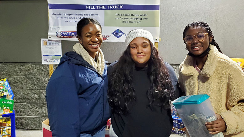 BSU members Maya Powell, Sarah Desrosiers, and Jade Bramwell volunteer for the Blair County Food Drive held in Nov. 2021.