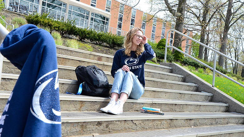 Gabrielle Davidson sits on the steps outside Oak Hall at Penn State Altoona