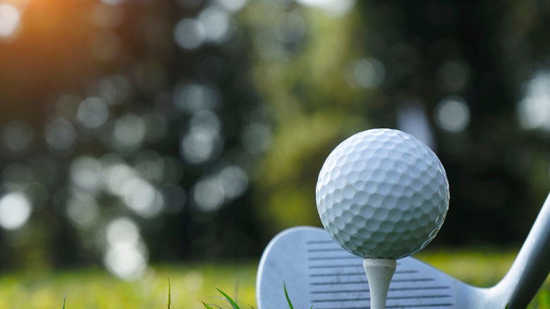 A golf ball and club
