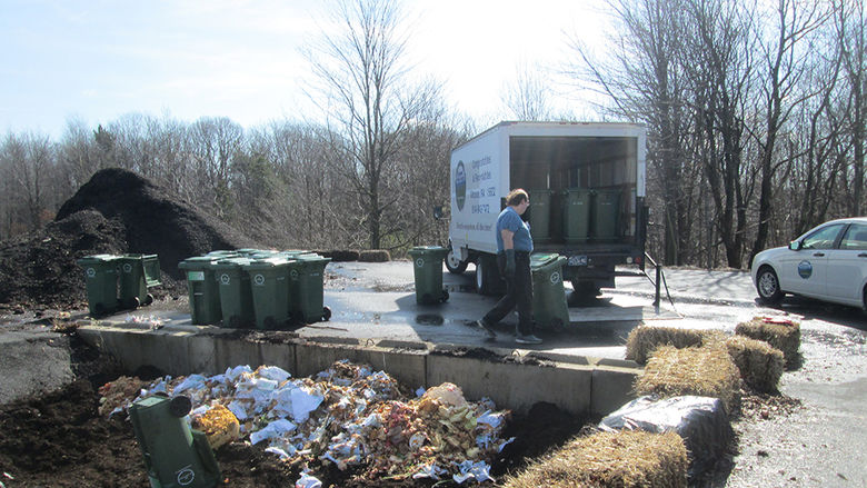 Student James Edwards helps unload food waste at the Ashville compost facility.