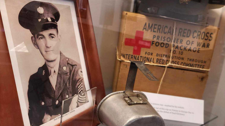 Personal items belonging to John C. Halloran now on display in the Smith Building. including a WWII-era photo, a canteen, and a American Red Cross food package.