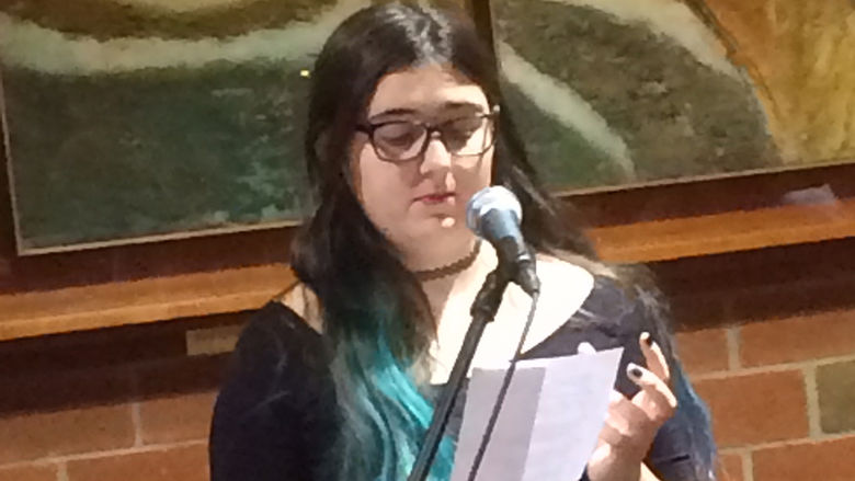 A student reading at the spring 2018 Hard Freight Cafe