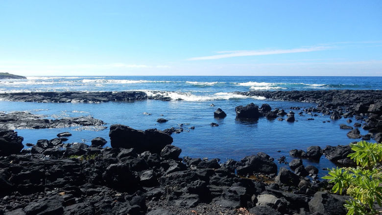 A black lava beach at Whittington Beach Park on the southern coast of the Big Island