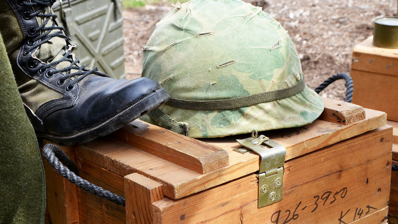 A military helmet sitting on top of a crate