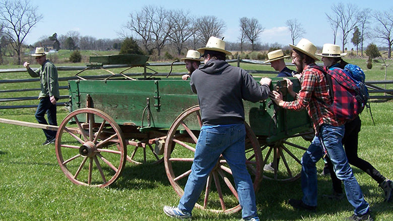 History students pushing a wagon