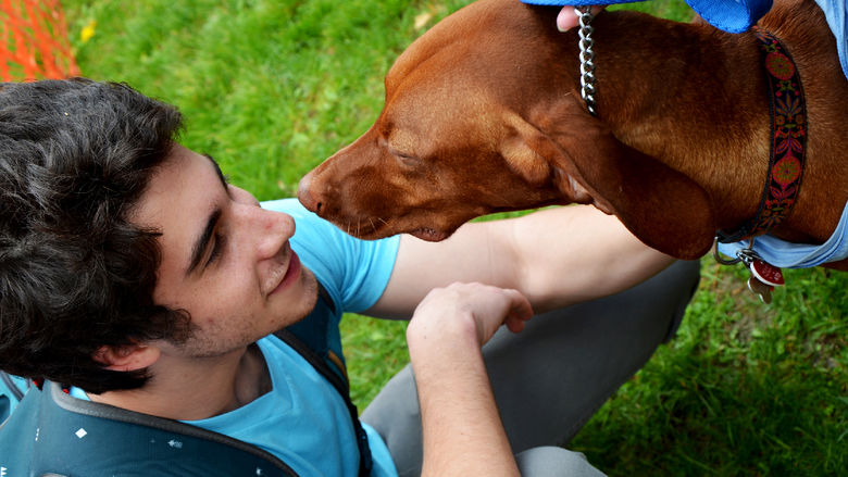 An Altoona student hanging out with a puppy at a Hugs for Hounds event