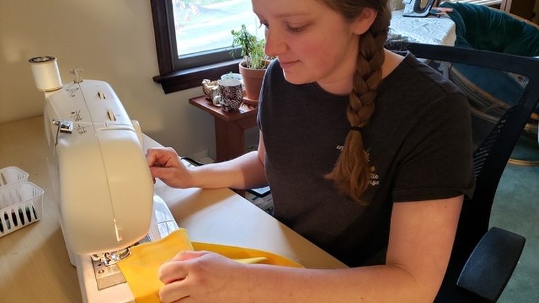 Huxford at sewing machine