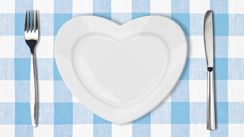A heart-shaped plate with a fork and knife.
