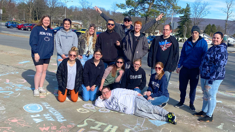 We Are Friends members Chalk the Walk at Penn State Altoona.