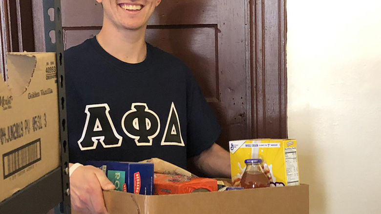 Matt Chetham organizes food for St. Luke’s monthly food pantry. 