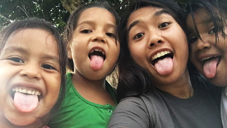 Elissa Calhoun poses for a silly picture with a few girls before dinner.