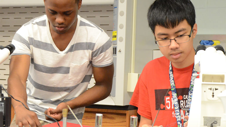 Students work in a science lab on campus