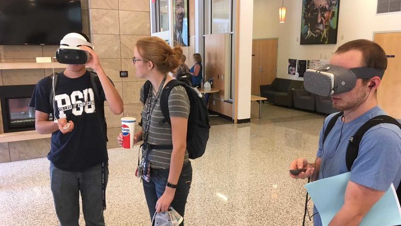 Students looking at 360 virtual reality videos