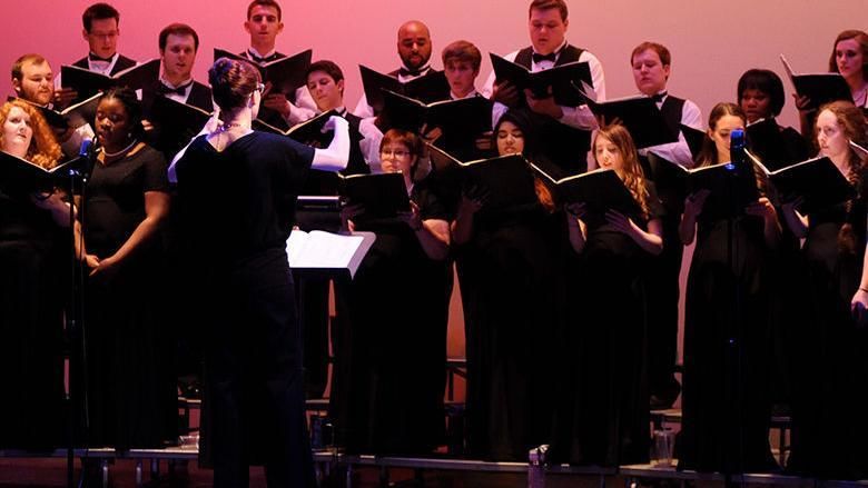 A choir wearing black performs a choral work