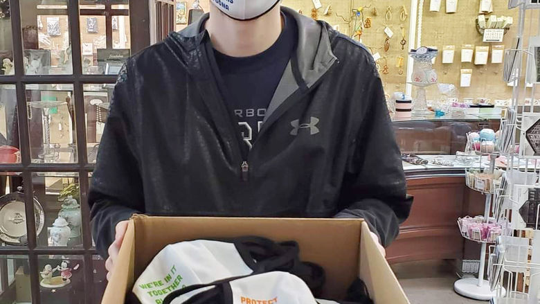 Joey Roesch shows off a box of face masks created for the Mask Up Altoona program.