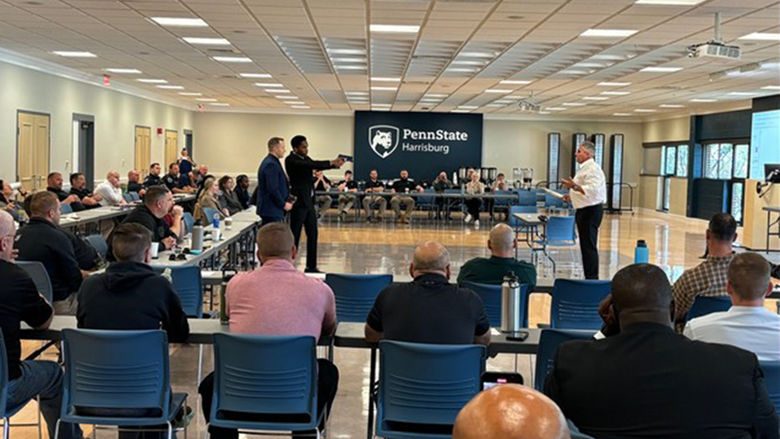 Second-year Penn State Altoona student Ray Ncube participates in a taser simulation exercise with officers from the Pennsylvania State Police as part of the Keystone Model crisis management workshop at Penn State Harrisburg.