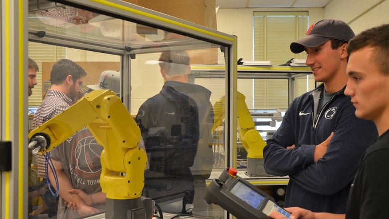 Engineering Students working with robots