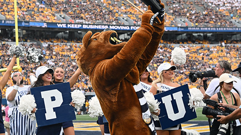Nittany Lion plays cowbell