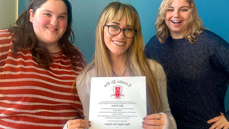 Communications major Mya Lutton displays her Lambda Pi Eta honor society certificate with recent Penn State Altoona graduates Eve Ergler and McKenzie Quirin.
