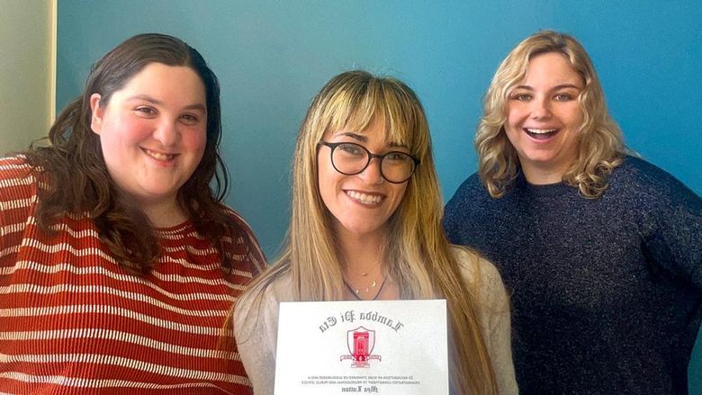 Communications major Mya Lutton displays her Lambda Pi Eta honor society certificate with recent Penn State Altoona graduates Eve Ergler and McKenzie Quirin.