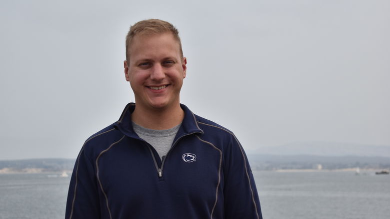 John McFarland stands in front of ocean