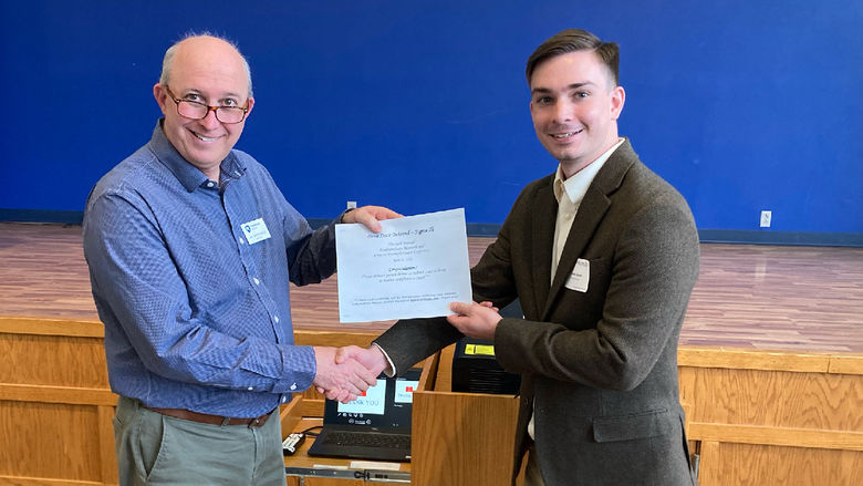 Penn State Altoona student Nicholas Glunt receiving second place honors for his psychology research poster at the spring 2022 Undergraduate Research and Creative Accomplishment Conference