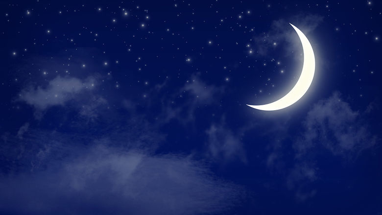A crescent moon in a dark, blue sky