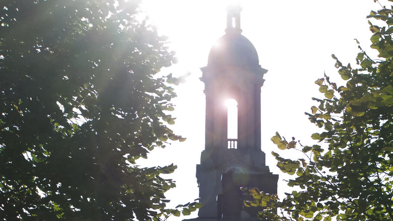 Sun streaming through Penn State's Old Main bell tower