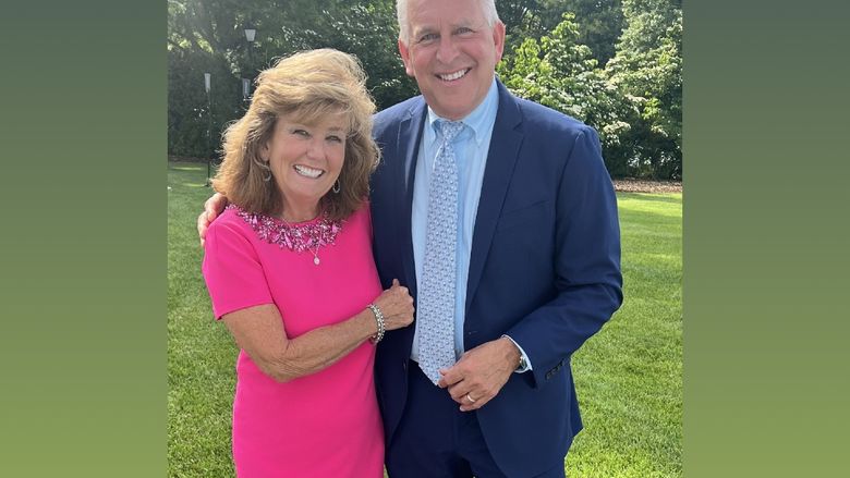 Stephen Pace and Rita Pace, smiling and standing outside in front of some trees