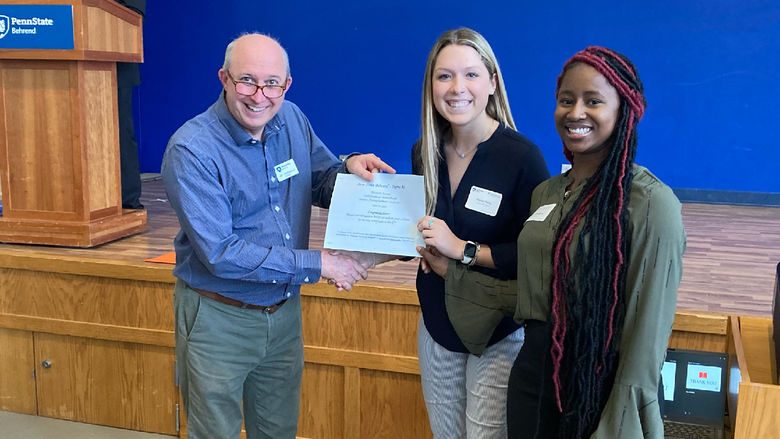 Penn State Altoona students Payton Perry and Makaylah Bangura receiving first place honors for their social sciences research poster at the spring 2022 Undergraduate Research and Creative Accomplishment Conference.