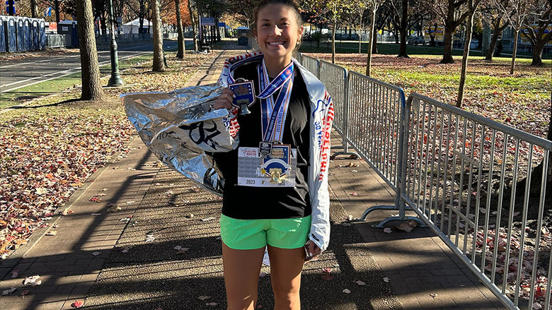 Manna Potter with her hardware at the 2023 Philadelphia Half Marathon
